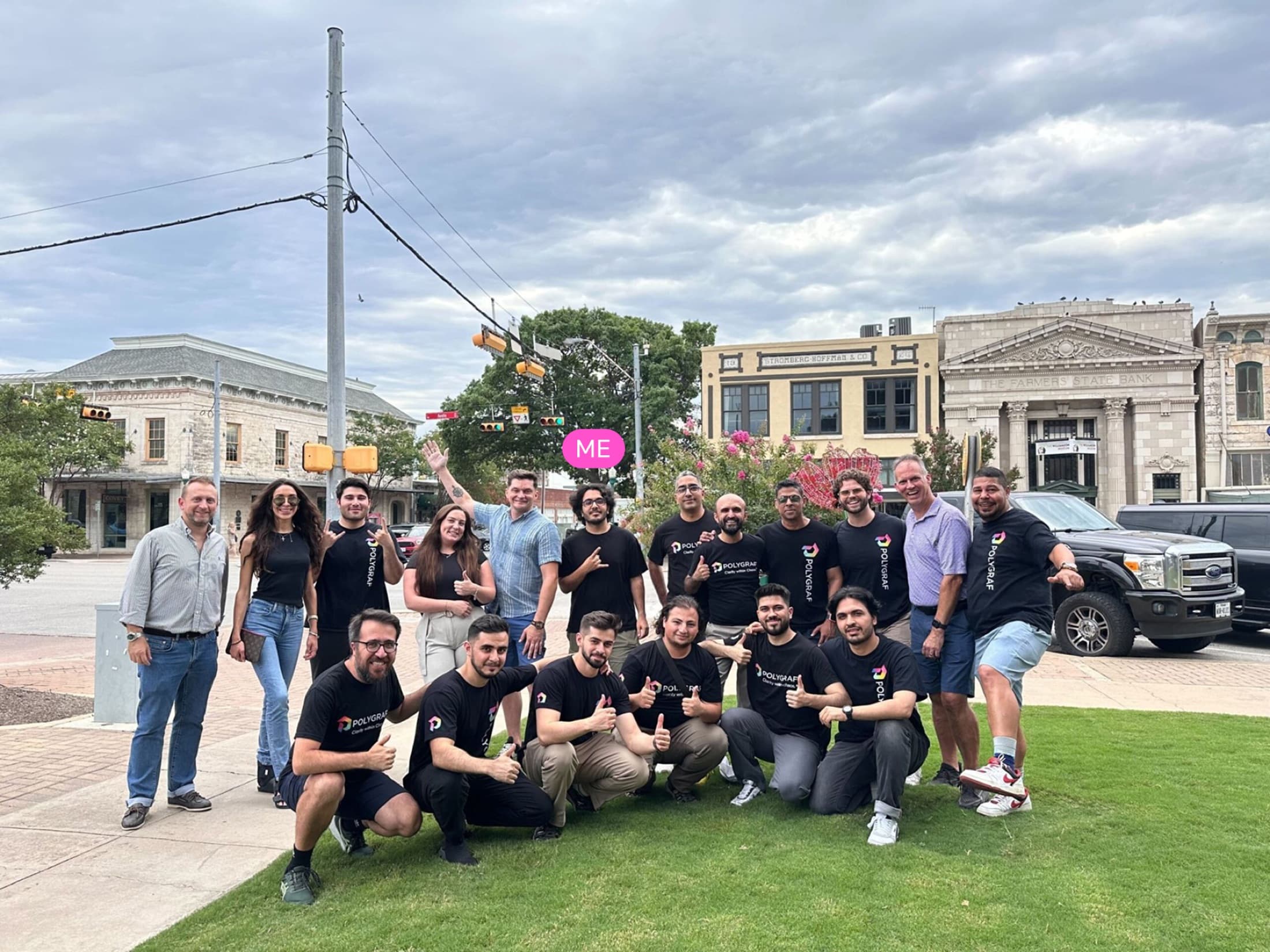 Polygraf AI team posing outdoors in front of historic downtown buildings